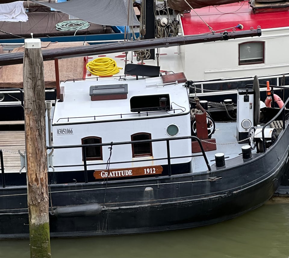 photo of a boat moored in a Rotterdam river, with the name GRATITUDE 1912