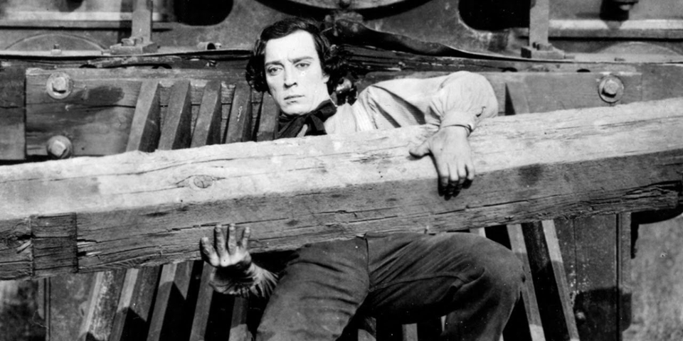 Buster Keaton holding a railway sleeper.
