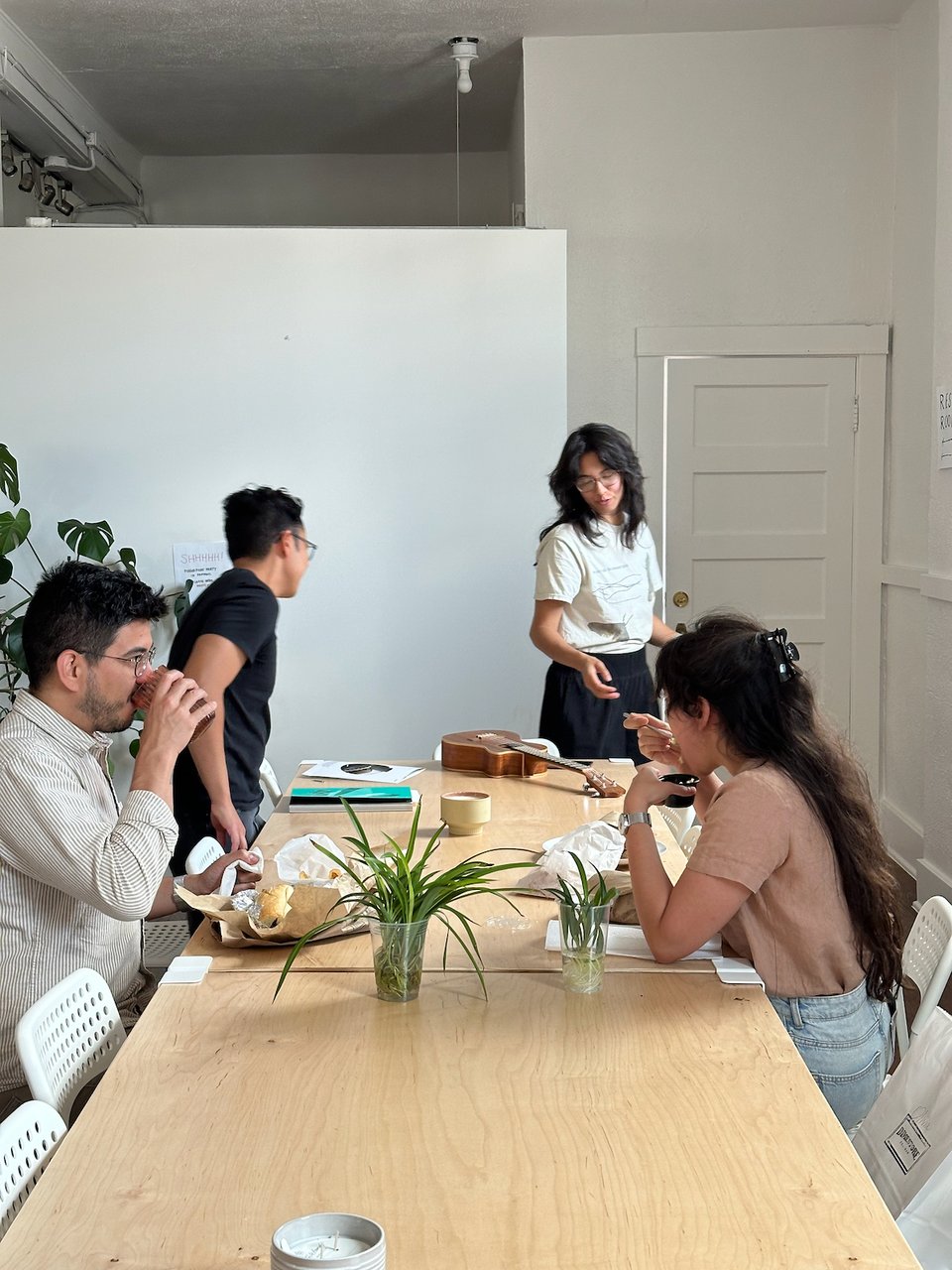 A group of hangs around a table.