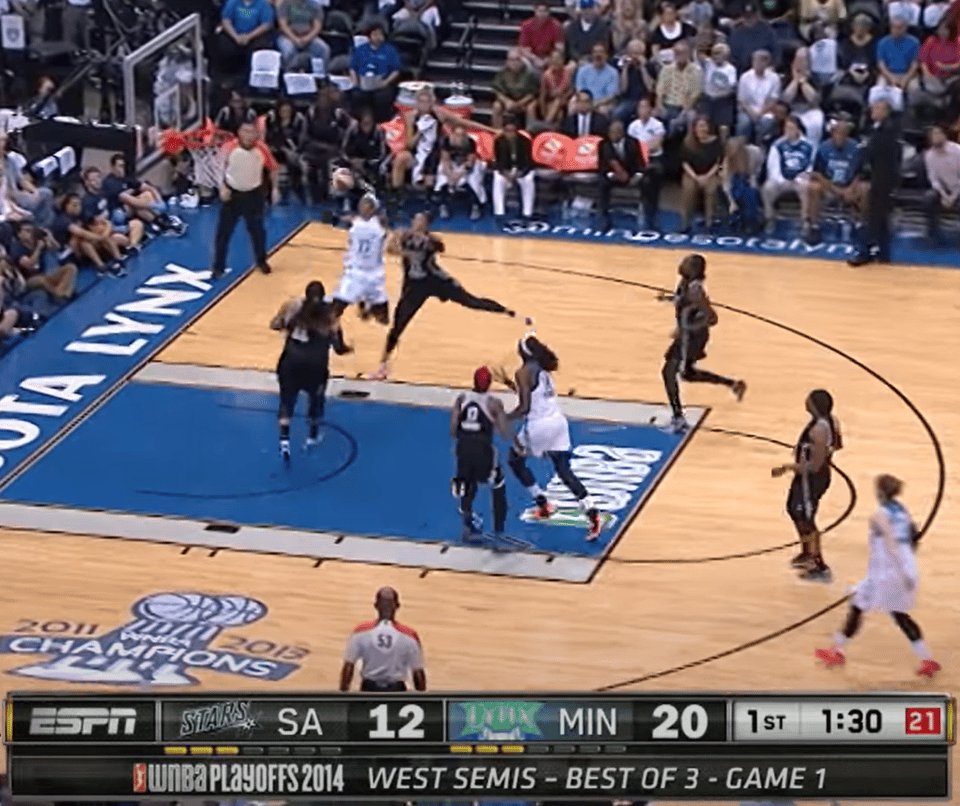 Maya Moore completing a transition alley-oop layup in a Minnesota Lynx game against San Antonio