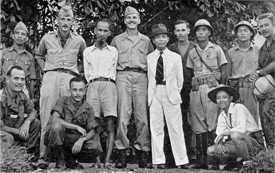 HCM standing with several US soldiers/spies and their local collaborators