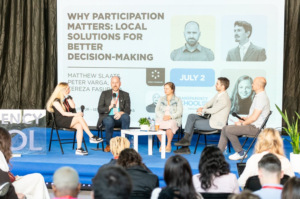a group of people sitting on a stage