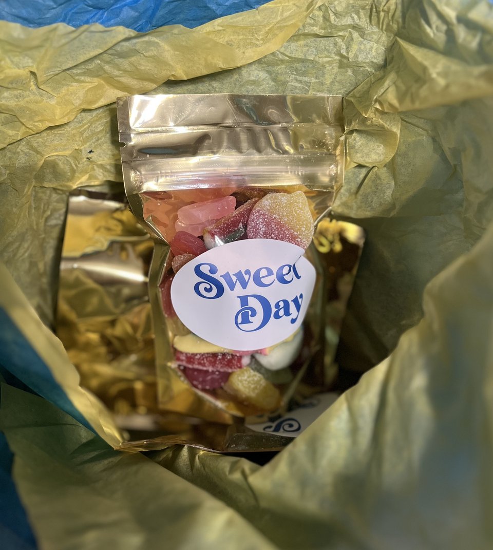 A bag of assorted, brightly colored gummy candy surrounded by tissue paper