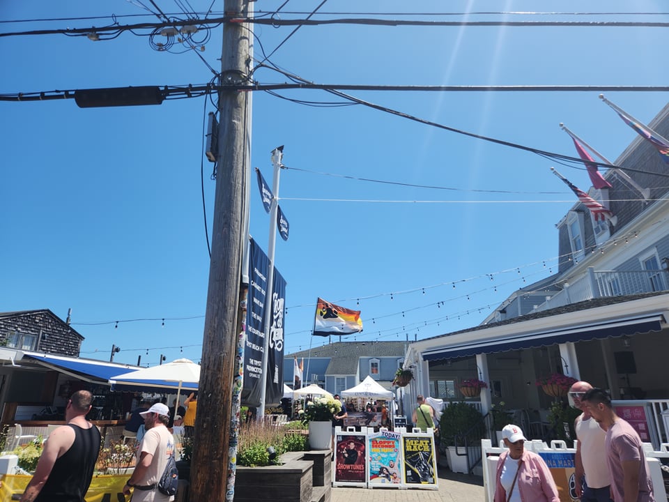 Outside the Crown and Anchor in Provincetown, with a huge Bear flag.