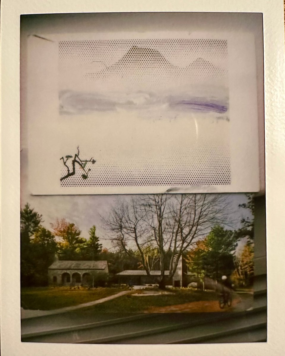 Instax photo of 2 postcards: top, a screen-print looking snowy mountain landscape, and bottom a photo-landscape of low buildings and trees