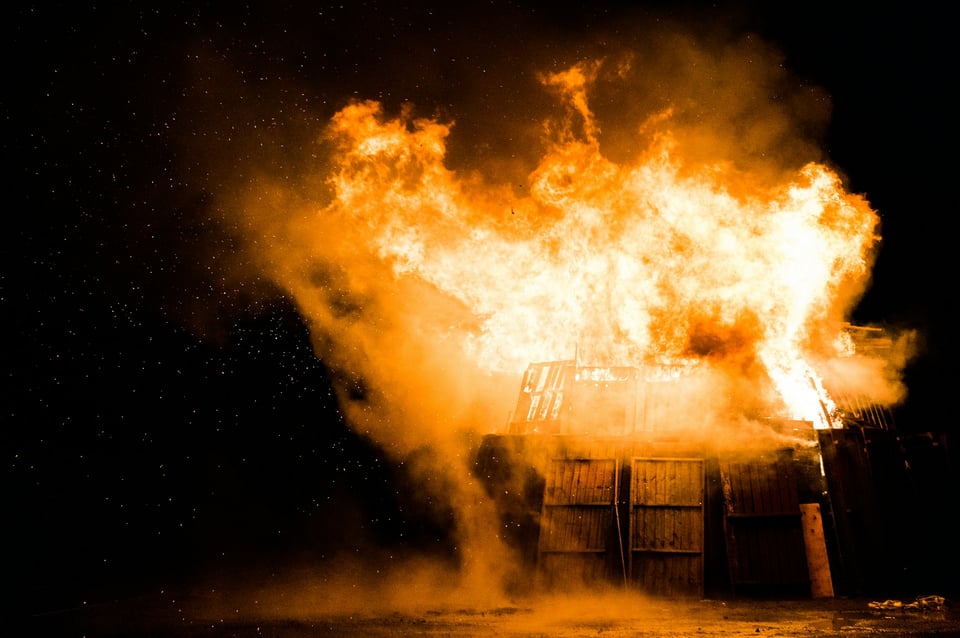 A dumpster, on fire. Photo by Stephen Radford on Unsplash.