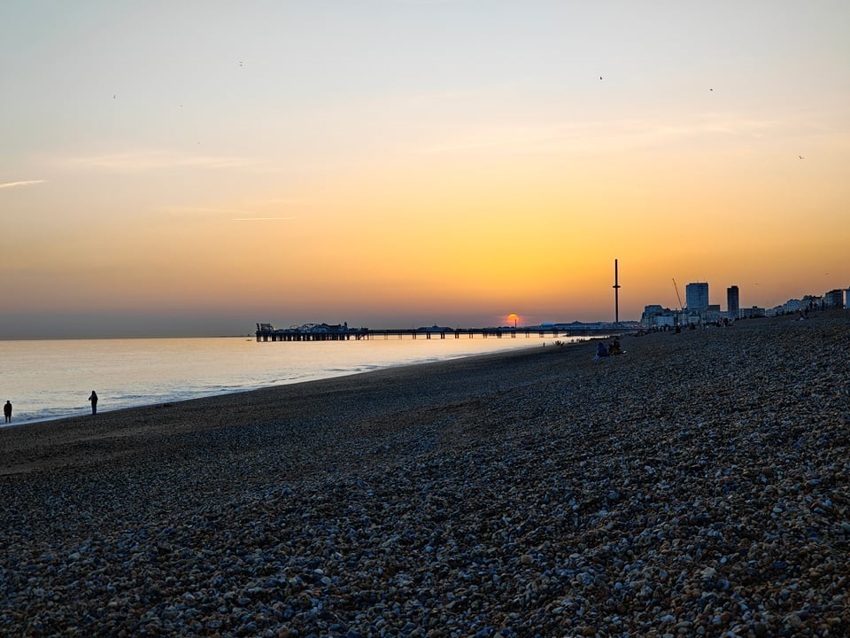 Brighton's pebble beach at sunset