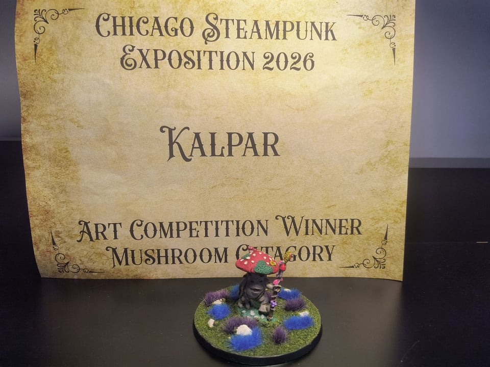 Picture of a mushroom miniature with a certificate for art competition winner at the 2026 Chicago Steampunk Exposition