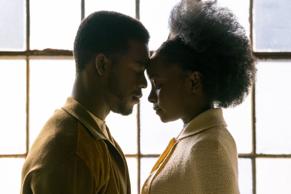 The two leads of if beale street could talk, both mid-darkskinned Black people, with their heads pressed together in front of a bright window