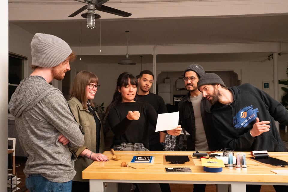 A group of people looking at Livvy’s print.