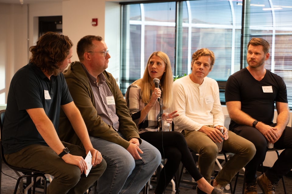 A panel of five is caught mid-action