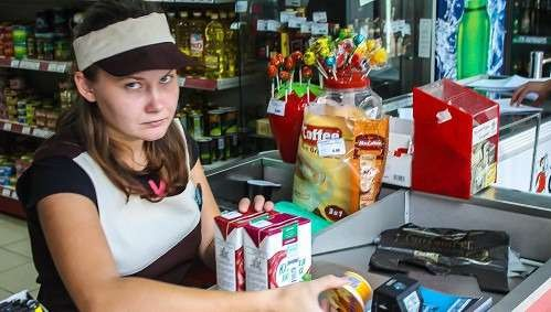 Grumpy cashier at a cash register