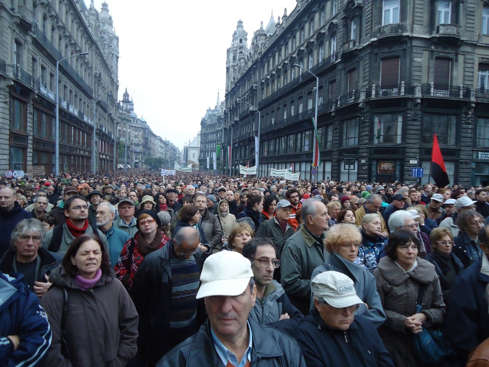 A photo of the crowd in Szabadsag Ter at a major opposition rally in October 2011. There is a huge crowd receding into the distance, of all ages and marching together (and wearing plenty of layers because it was very cold and rainy that day!)
