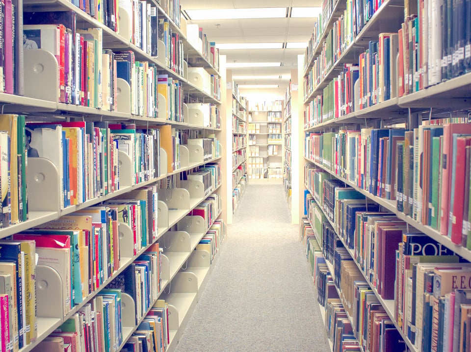 Bookshelves in a library receding into the background