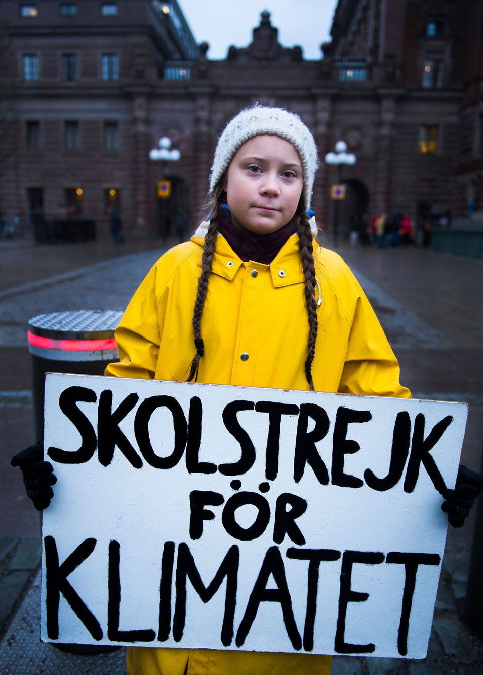 Swedish activist Greta Thunberg holding a sign, 2018.