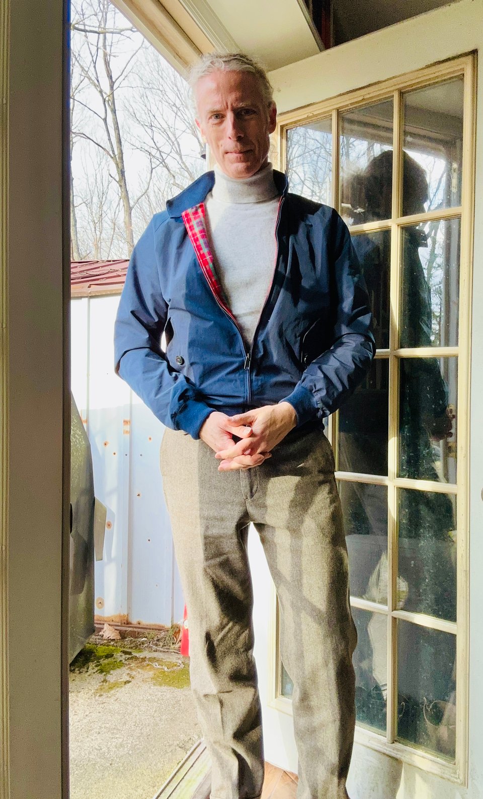 photo of middle-aged white man in navy Baracuta G9 Harrington jacket, silver-white turtleneck, and light-olive tweed pants, looking pretty hot, admit it