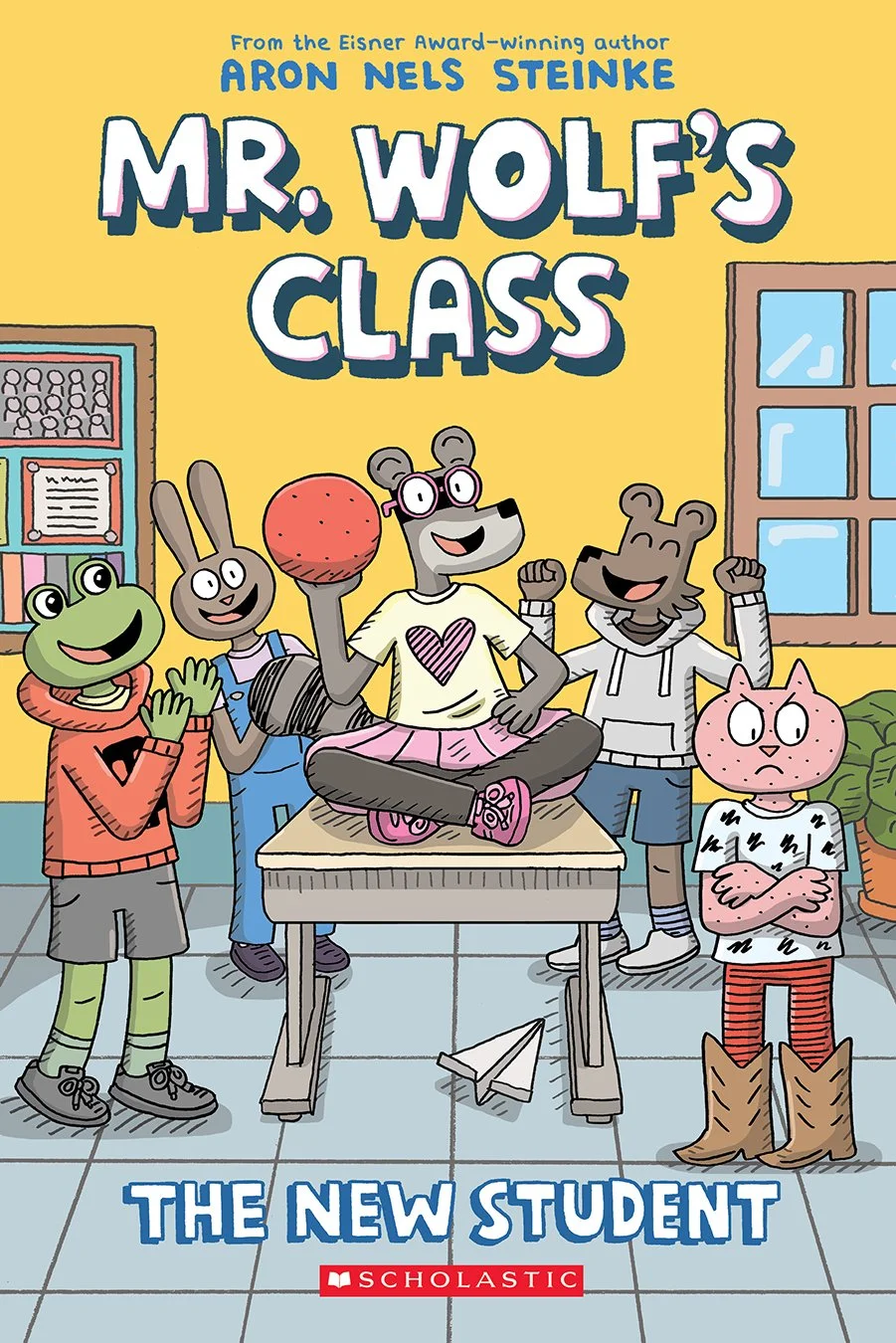 Cover of a comic book. Text: Mr. Wolf's Class, The New Student. From the Eisner award-winning author Aron Nels Steinke. Scholastic." The cover shows a number of school-aged children who are anthropomorphic animals. A mouse girl sits on top of a school desk, holding a rubber dodge ball and smiling, surrounded by mostly cheering friends. On the right, a pink cat looks away with jealousy or disappointment.