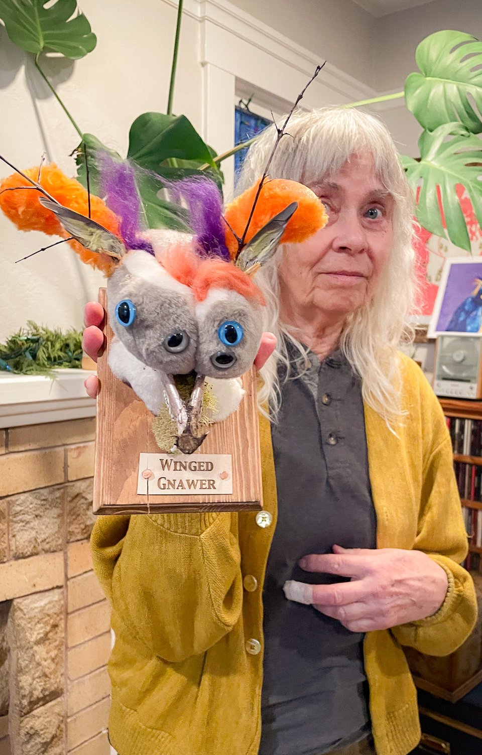 Explorer holding up their specimen, the winged gnawer