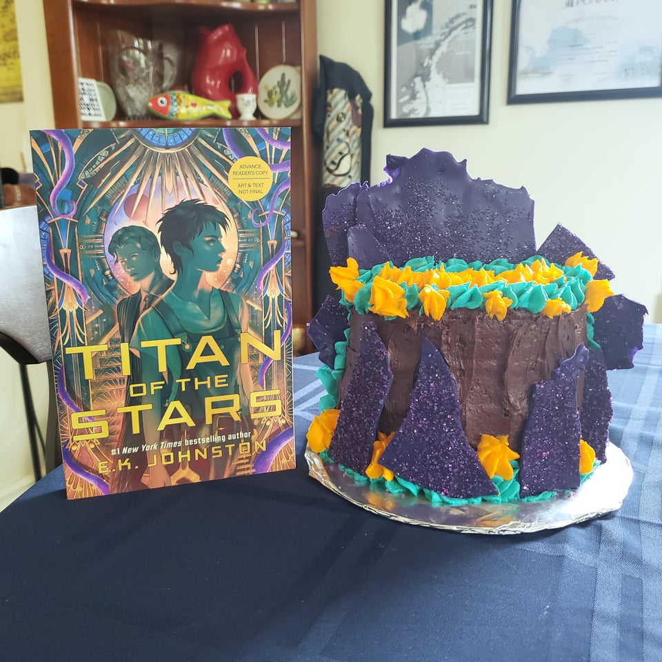 EK Johnston's TITAN OF THE STARS with a cake in corresponding colours next to it.