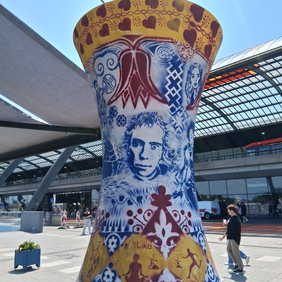 A huge porcelain pot with caricatures painted on it. One is staring directly at you.