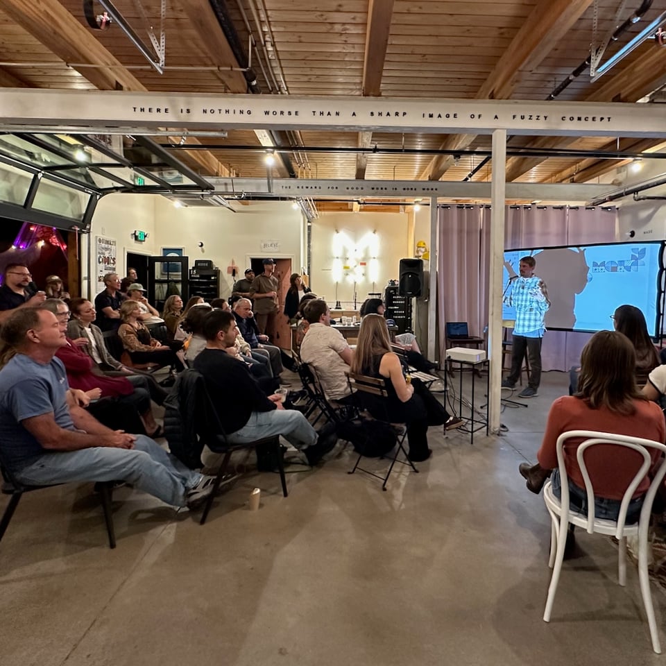 A crowd in a beautiful studio space.