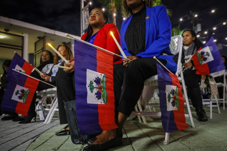 People attend a candlelight vigil Feb. 3 in Miami for Haitians living in the United States under temporary protections.