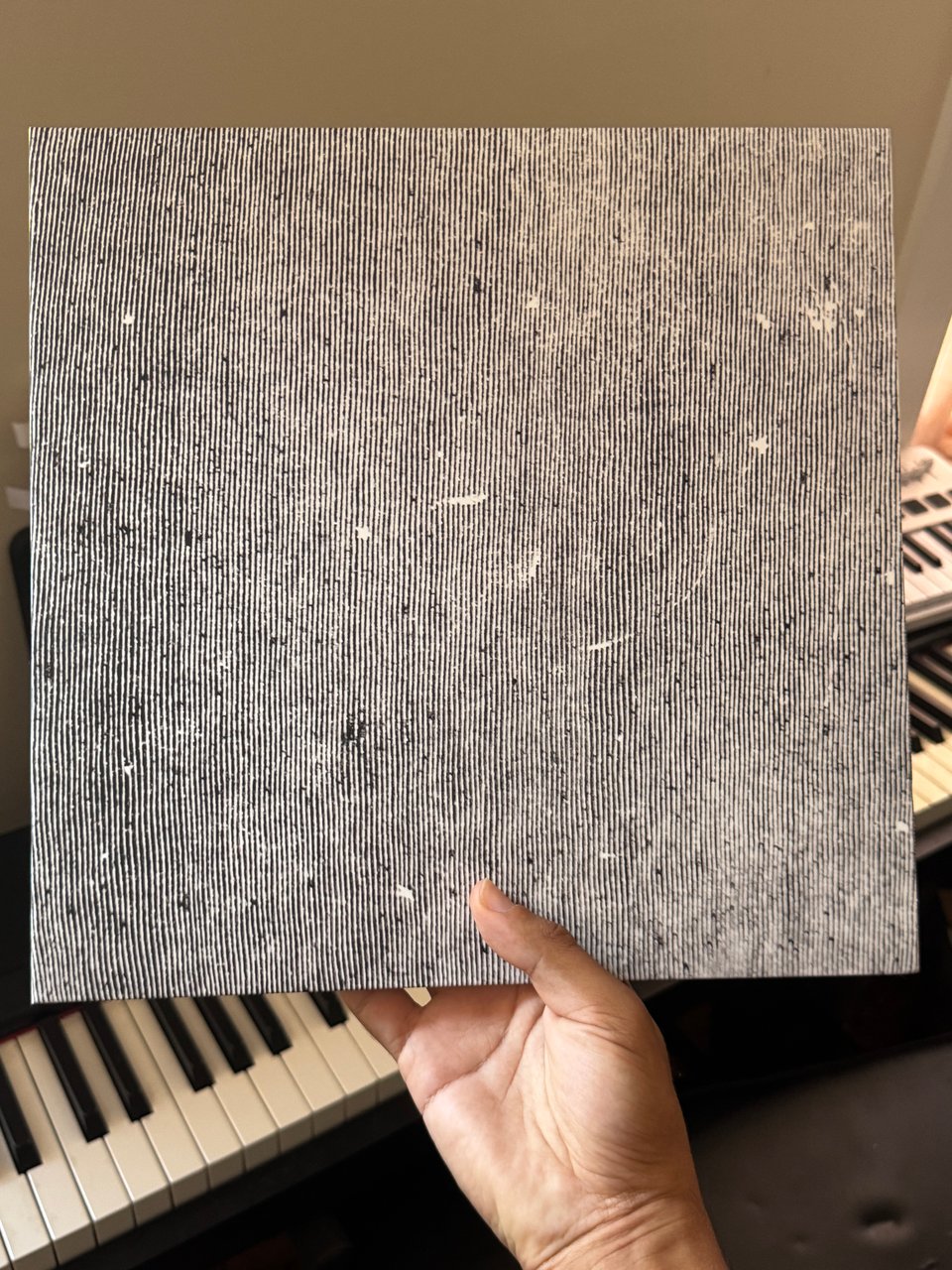 the vinyl record of the album Hey What by Low. Its cover is streaks across a metallic grey.