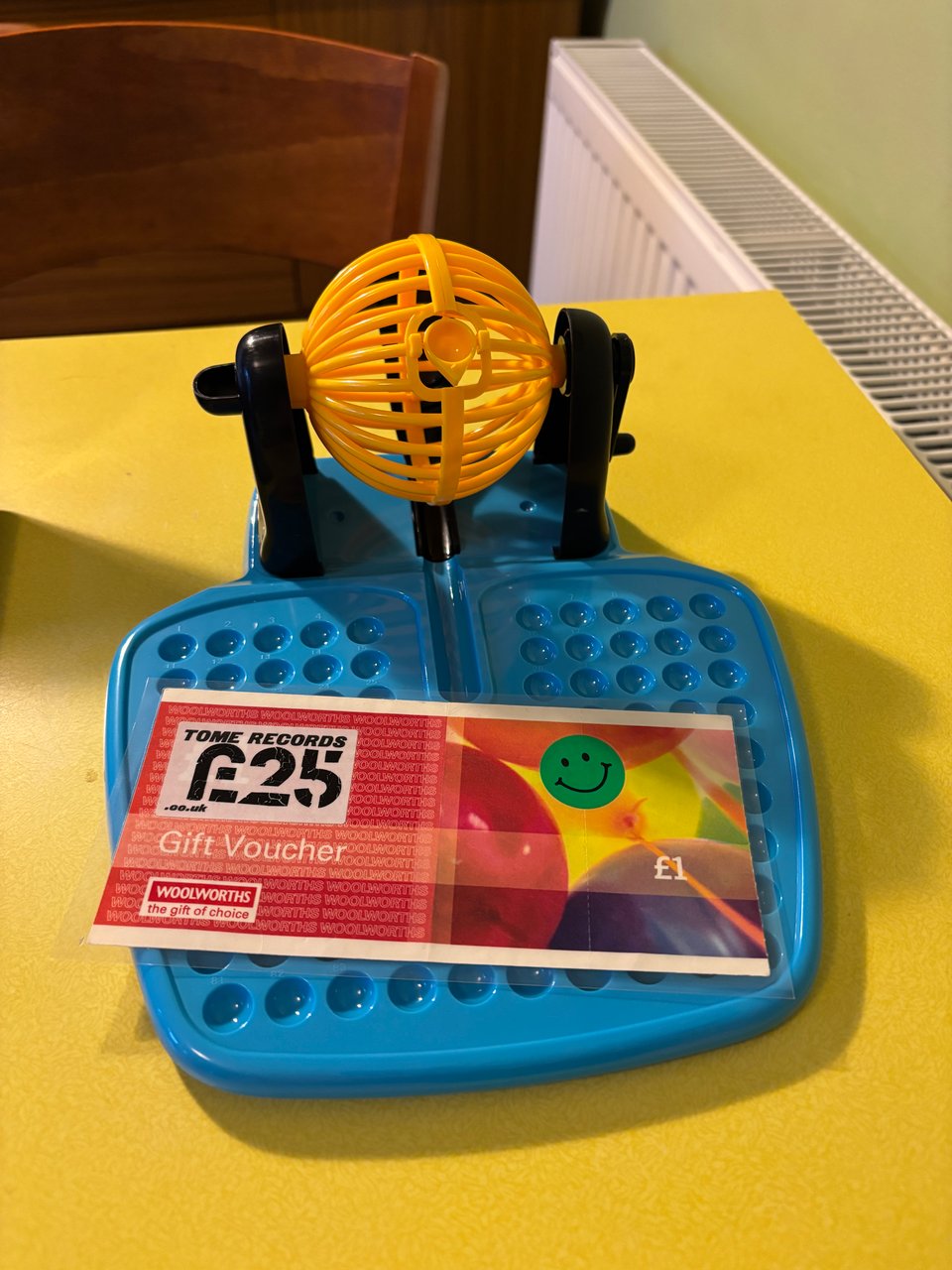 A chunky plastic bingo calling machine (sans balls), with a homemade Tome/Woolworths gift voucher.