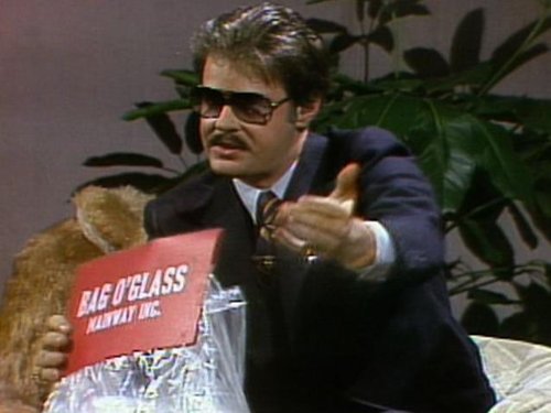 a man in a suit holding a sign