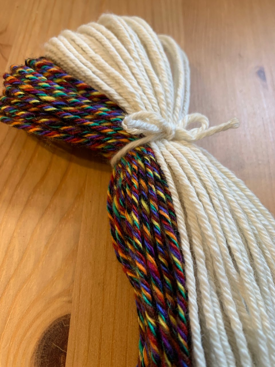 a bundle of extra-large, handspun, rainbow and white tzitzit string.