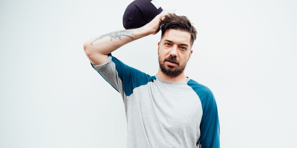 Aesop Rock holding his head.