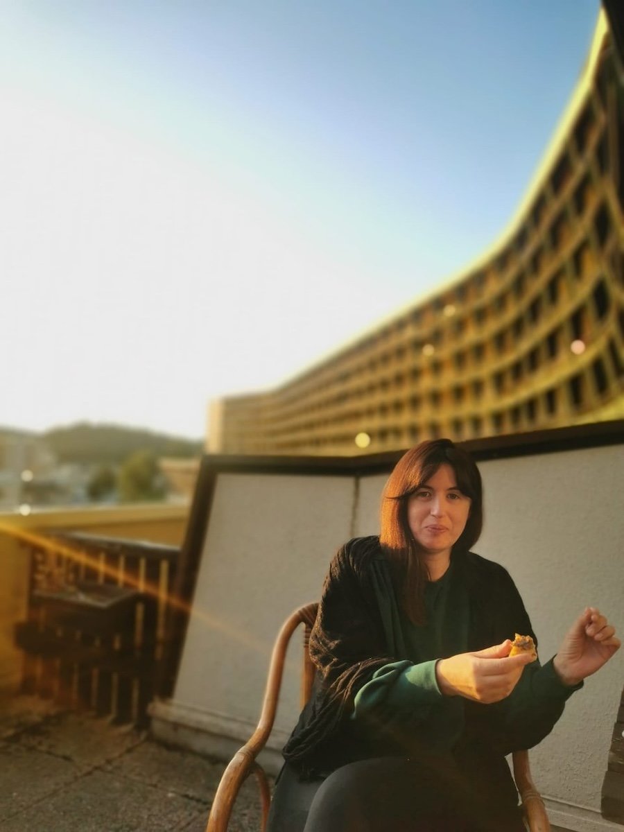 Lucie prenant un bain de soleil sur le balcon de son studio