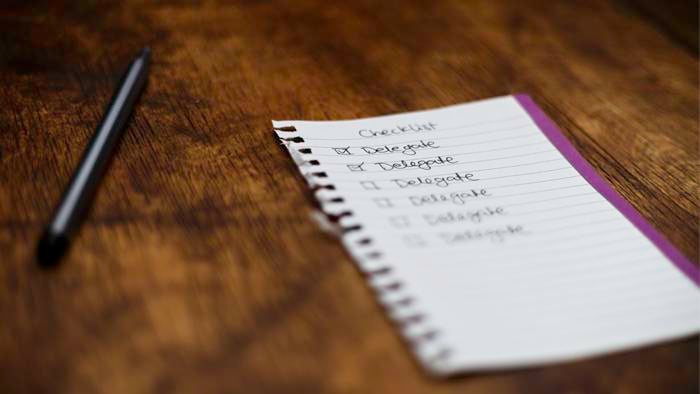 a notepad with a pen next to it