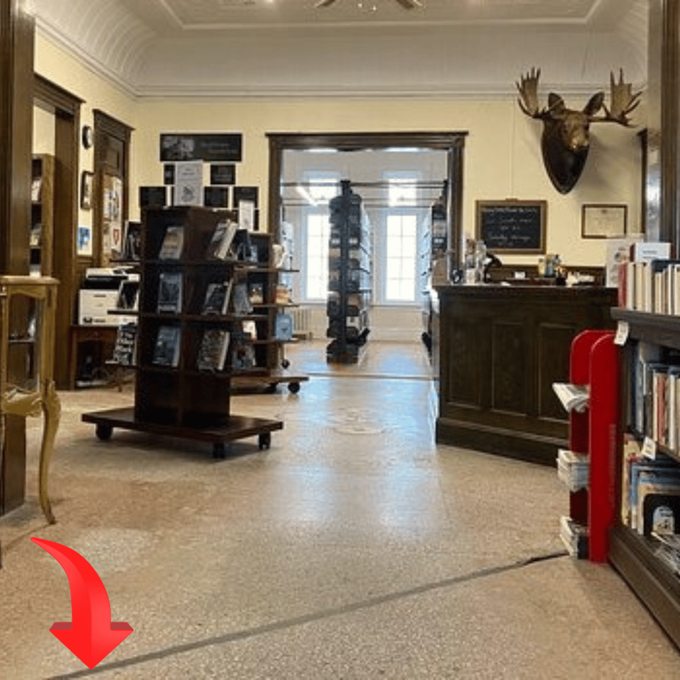 The entrance to the library in Derby Line, Vermont. The black line (see arrow) delineates the Canada-U.S. border.