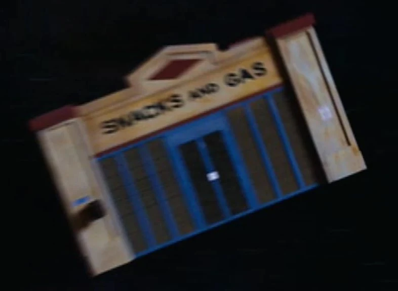 Clara's TARDIS shaped like an American diner ("SNACKS AND GAS") spinning through space.