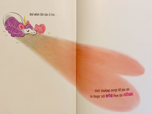 Image from Itty-Bitty Kitty-Corn as described in the text: the unicorn and Kitty side by side, their shadows making a heart.