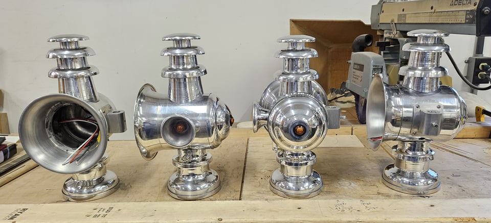 Four silver-colored lights sit atop a work table