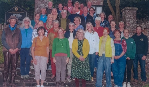 A group of people arranged on the steps of a church.