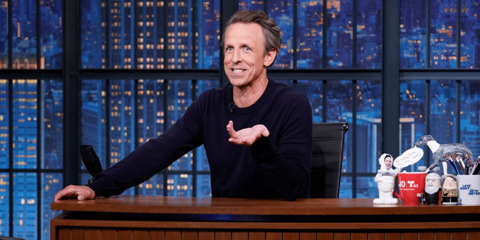 Seth Myers at his desk.