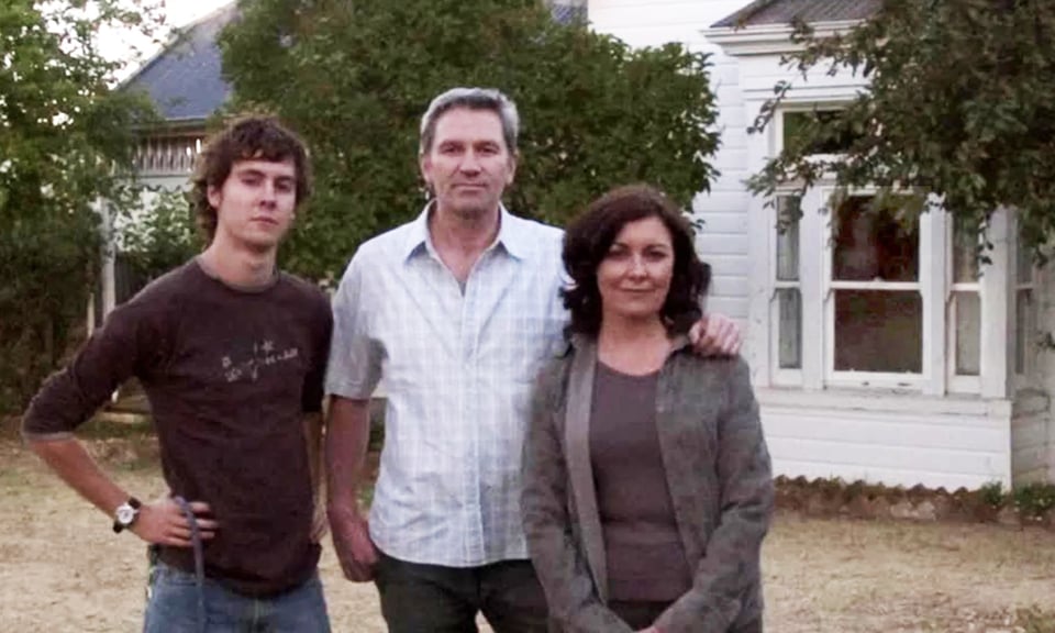 The mother, father and surviving son outside their house in Lake Mungo (but what's that in the window?)