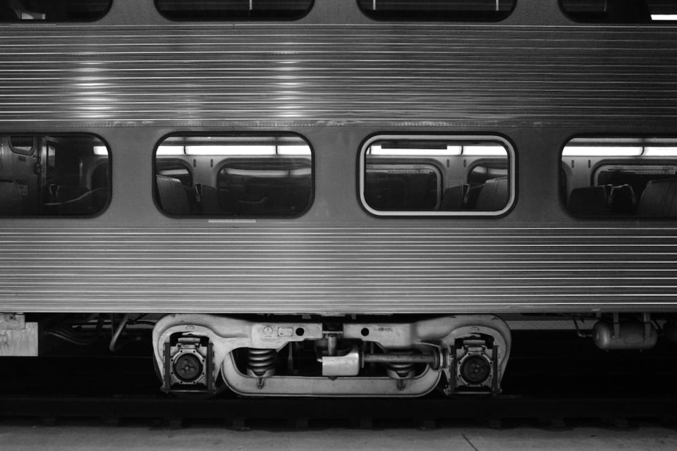 A black and white photo of a commuter train.
