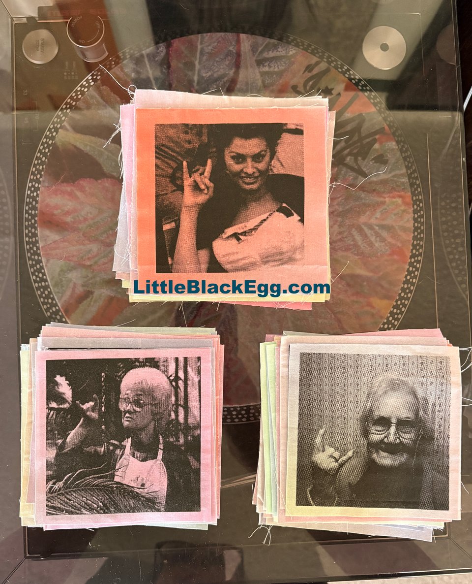 Alt text: Three piles of screen printed patches on a record player
