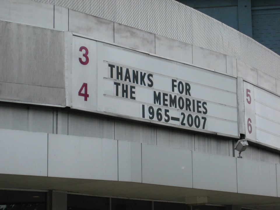 Photo of the movie-listing sign for a closed-down multiplex, reading "THANKS FOR THE MEMORIES 1965-2007"