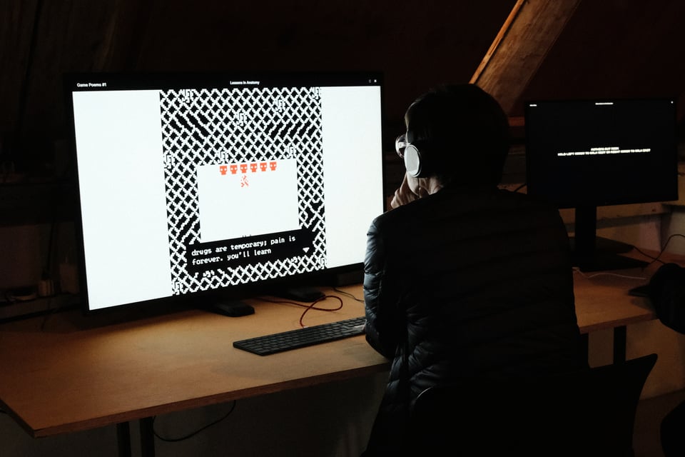 A person plays a videogame on a screen