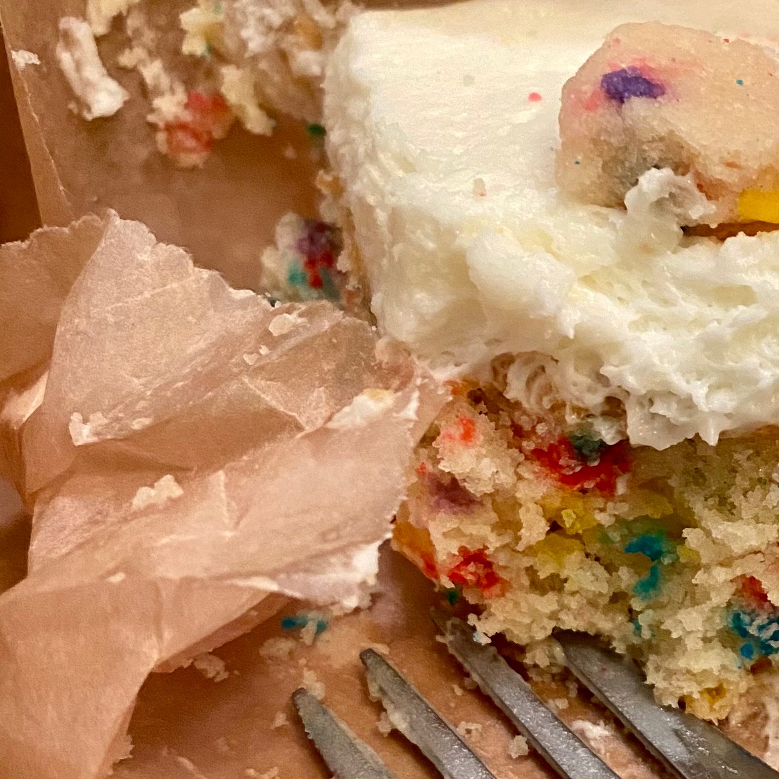 Close-up of a half-eaten slice of confetti cake