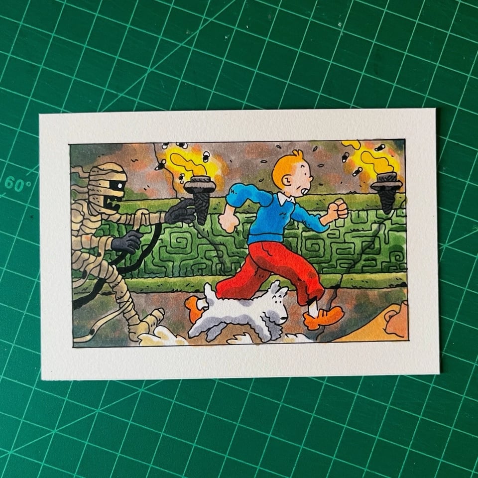 illustration of tintin and snowy being chased down a temple hallway by a mummy