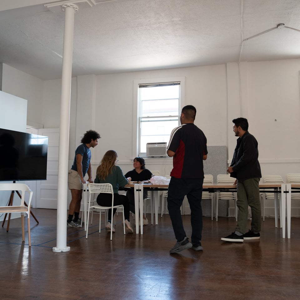 A group of people standing around a table.