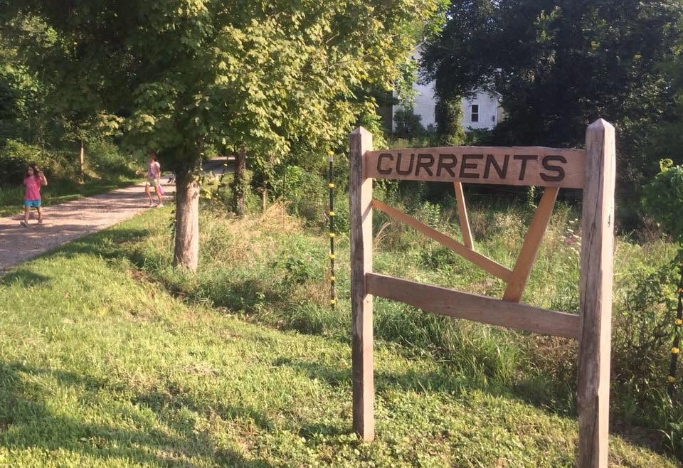 Picture of a wooden sign with the word "currents" on it