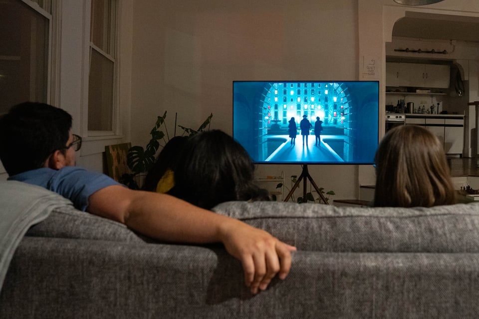 A group of friends watching a TV show.