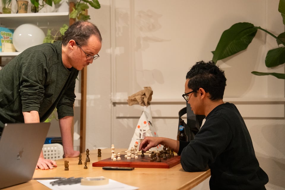 Ben and Norton playing chess at a table.